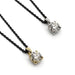 Two 0.50ct lab diamond pendants in 14kt yellow and white gold on black chains