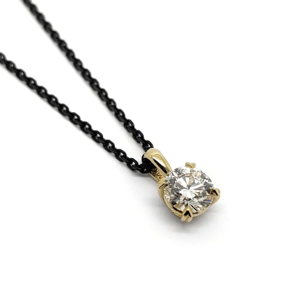 0.50ct lab diamond pendant in 14kt yellow gold on a black chain, white background