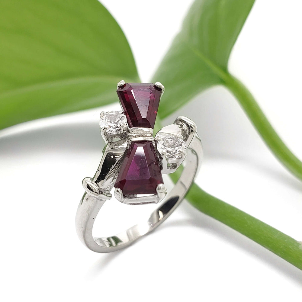 10kt white gold cocktail ring with red glass and cubic zirconia, shown with green leaf background