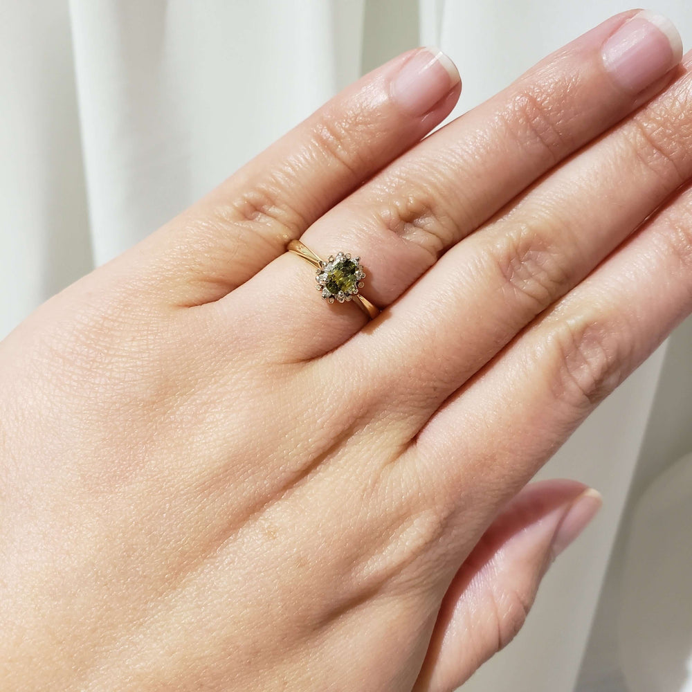 10kt yellow gold sapphire and diamond halo ring shown on hand