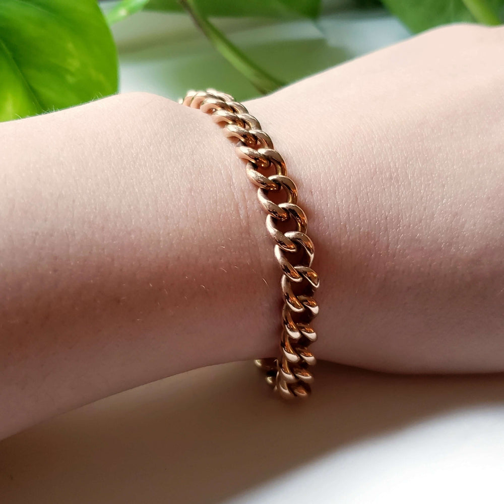 14K rose gold vintage curb link bracelet worn on a wrist