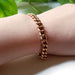 14K rose gold vintage curb link bracelet worn on a wrist