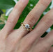 14k gold diamond leaf wedding ring stacked with solitaire engagement ring on hand