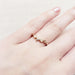 14k rose gold leafy wedding ring with diamond shown on a hand