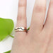 14k rose gold mountain range wedding ring with blackened detail, shown on hand