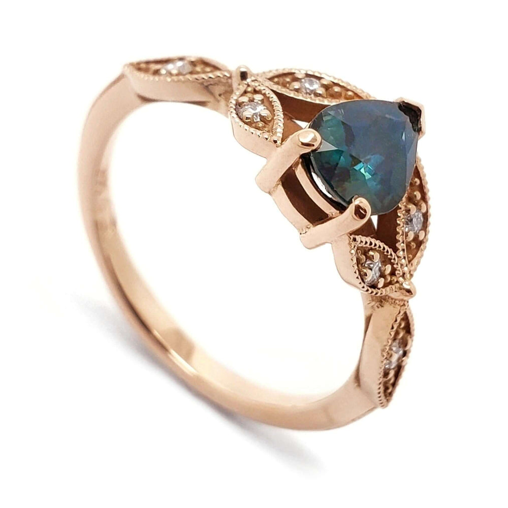 14k rose gold ring with pear-shaped teal sapphire and leaf-set Canadian diamonds