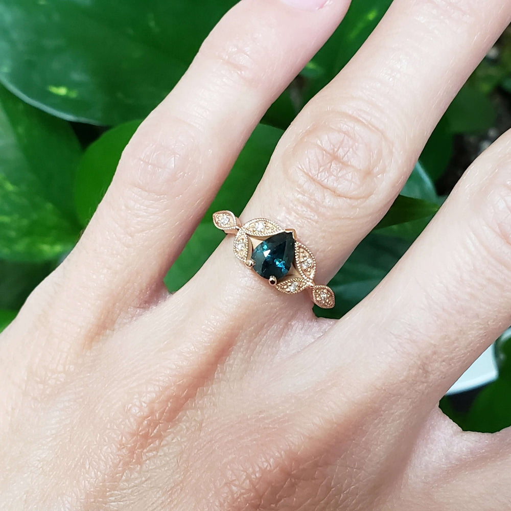 14k rose gold teal sapphire and diamond leaf ring shown on hand