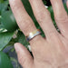 14k white and rose gold mountain range wedding ring shown on hand