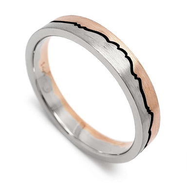 14k white and rose gold wedding ring with mountain range design and blackened groove