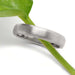 14k white gold brushed wedding ring displayed on a green plant stem