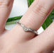 14k white gold chevron diamond wedding ring worn on a hand
