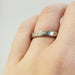 14k white gold diamond wedding ring with millgrain detail shown on hand