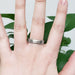 14k white gold flat wedding ring with brushed finish shown on hand