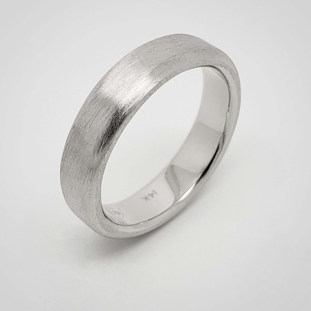 14k white gold flat wedding ring with brushed finish, side angle