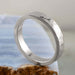 14k white gold hammered wedding ring displayed on blue stone