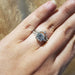 14k white gold lab diamond leaf wedding ring stacked with a solitaire engagement ring on a hand