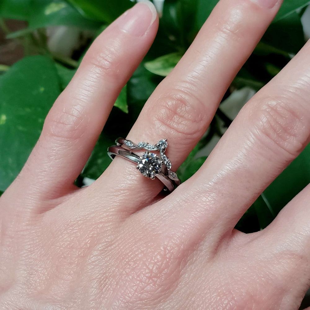 14k white gold leafy diamond wedding ring stacked with solitaire engagement ring
