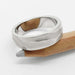 14k white gold topography wedding band with carved texture on a wooden pencil