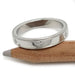 14k white gold wedding band with star-set Canadian diamonds, resting on a pencil