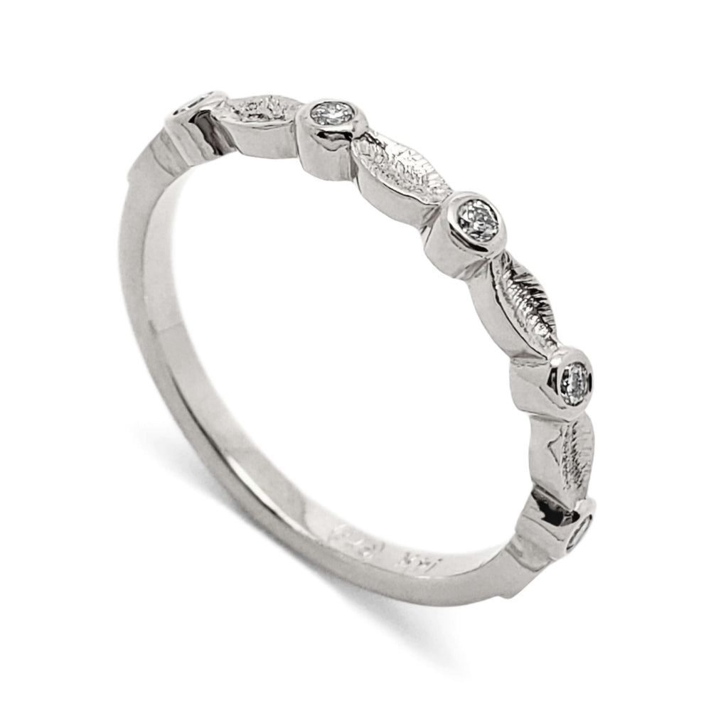 14k white gold wedding ring with textured leaf details and bezel set Canadian diamonds