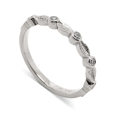 14k white gold wedding ring with textured leaf details and bezel set Canadian diamonds