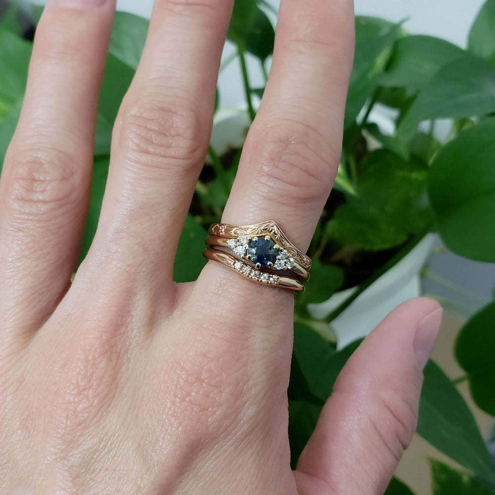 14k yellow gold chevron wedding ring stacked with sapphire and diamond rings