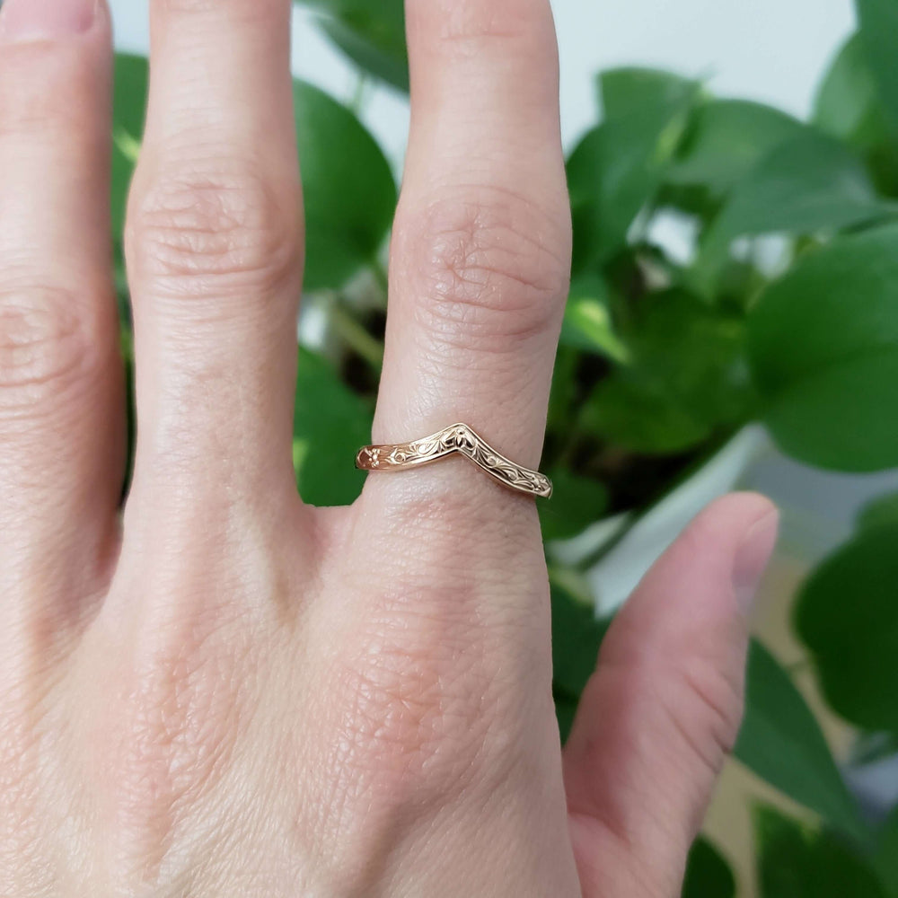 14k yellow gold chevron wedding ring with engraving, worn on hand