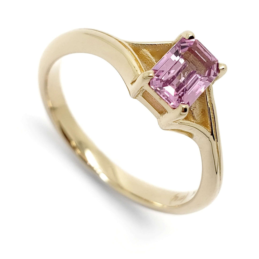 14k yellow gold engagement ring with emerald cut pink sapphire in split shank setting