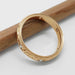 14k yellow gold engraved diamond wedding band shown on its side with pencil