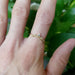 14k yellow gold leaf diamond wedding ring on hand, single band