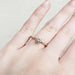 14k yellow gold moissanite engagement ring with engraved band shown on hand