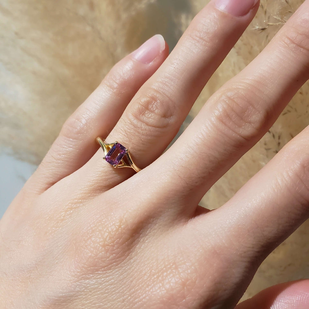 14k yellow gold pink sapphire ring worn on hand in natural light