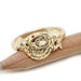 14k yellow gold snake ring with champagne diamond and ruby eyes, resting on pencil