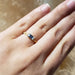 14kt yellow and white gold baguette gemstone ring shown on a hand