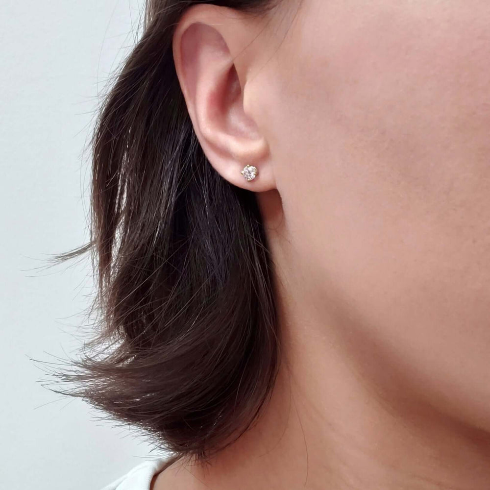14kt gold lab diamond stud earring worn on ear
