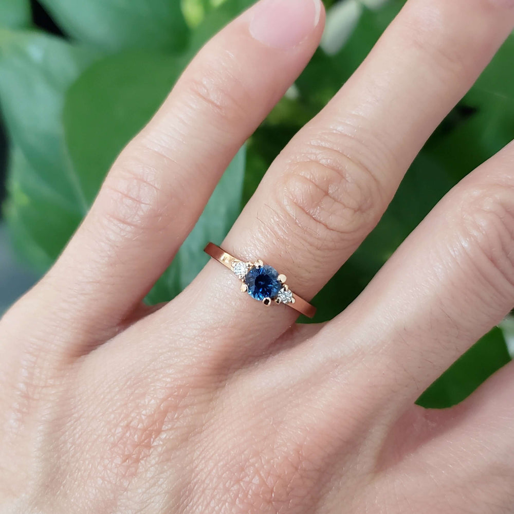 14kt rose gold Montana sapphire and diamond ring worn on hand