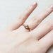 14kt rose gold bezel-set diamond ring worn on hand