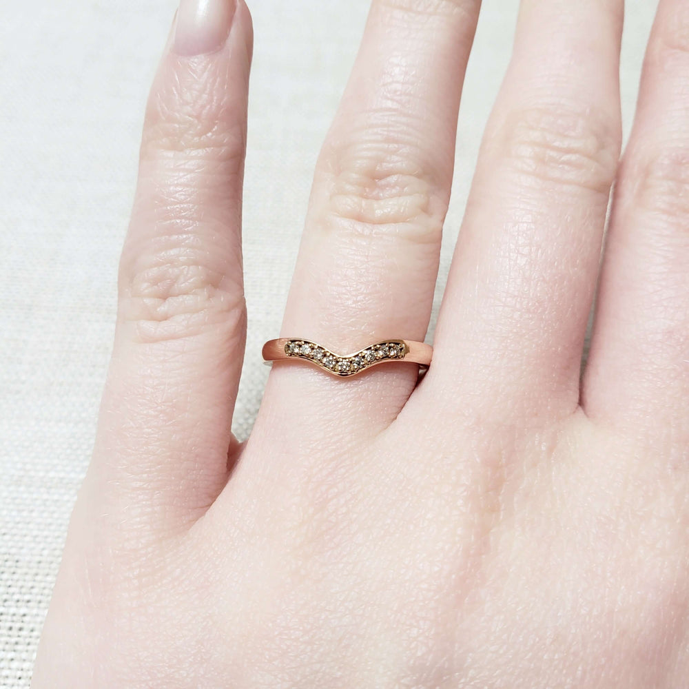 14kt rose gold chevron diamond band worn on a hand