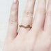 14kt rose gold chevron diamond band worn on a hand
