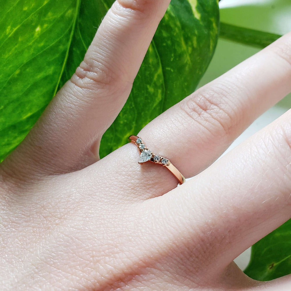 14kt rose gold chevron diamond wedding ring shown on hand