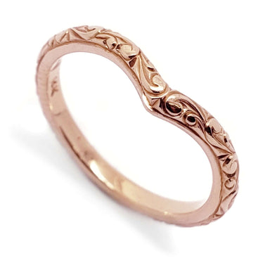 14kt rose gold chevron wedding ring with intricate hand engraving, close-up view