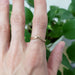 14kt rose gold chevron wedding ring with scroll engraving worn on hand