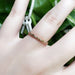 14kt rose gold diamond wedding ring worn on hand, showing delicate profile