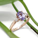 14kt rose gold engagement ring with purple sapphire and lab-grown diamonds beside green leaves