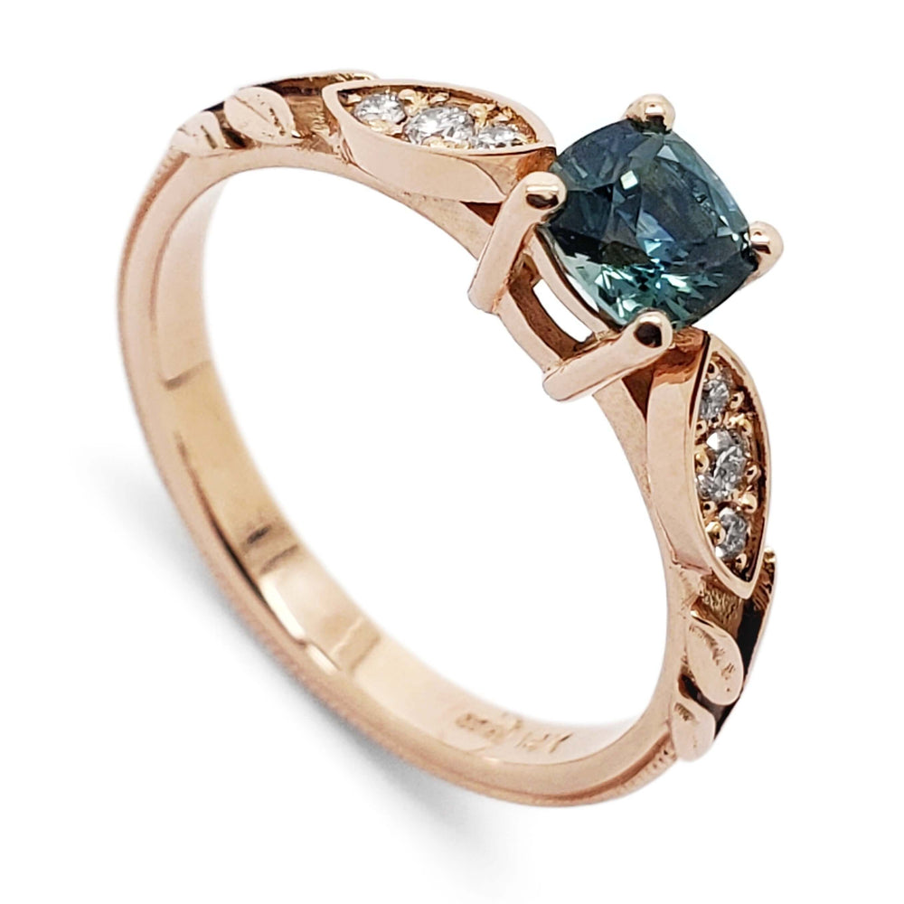 14kt rose gold engagement ring with cushion teal Montana sapphire and Canadian diamonds in leafy setting
