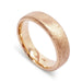 14kt rose gold flat wedding band with saw blade finish, angled view