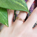 14kt rose gold floral engraved wedding ring shown on a hand
