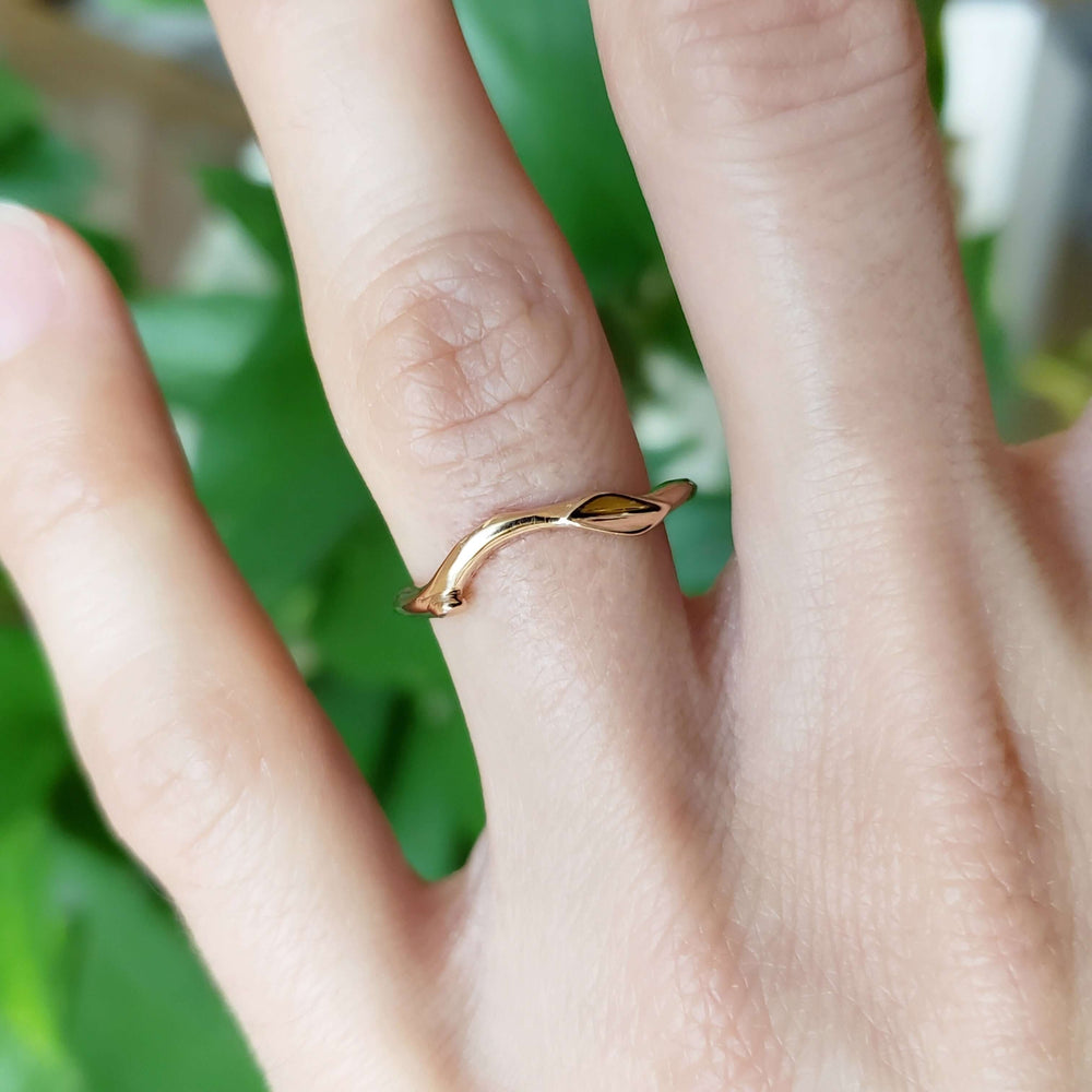 14kt rose gold leaf and twig wedding ring shown on hand