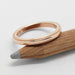 14kt rose gold millgrain wedding ring displayed on a wooden pencil