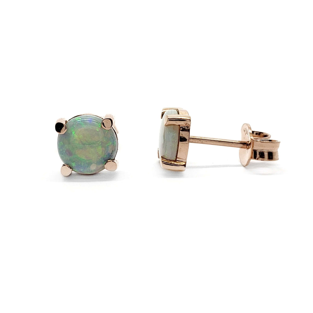 Round cabochon opal stud earrings in 14kt rose gold on white background